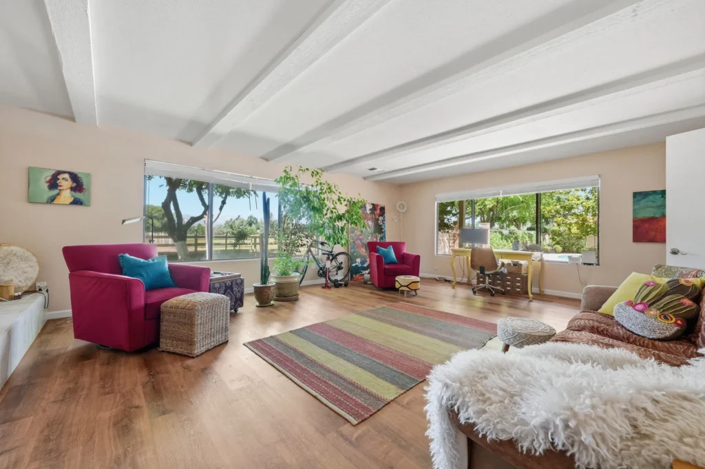 Family room with fireplace, arranged for gathering.