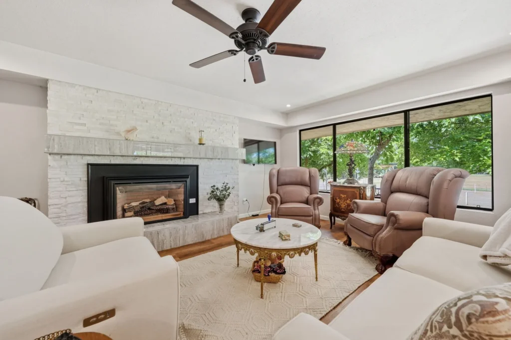 Great room with natural stone fireplace and high ceilings.