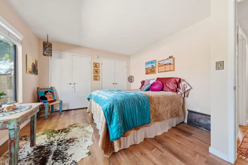 Guest bedroom with window light and neutral finishes.