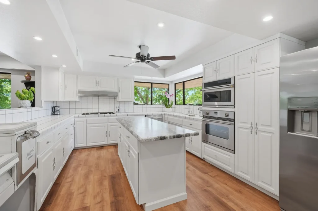 Bright kitchen with large island and generous counter space.