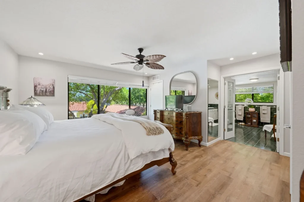 Primary suite with views to mature trees at Churn Creek Estate.